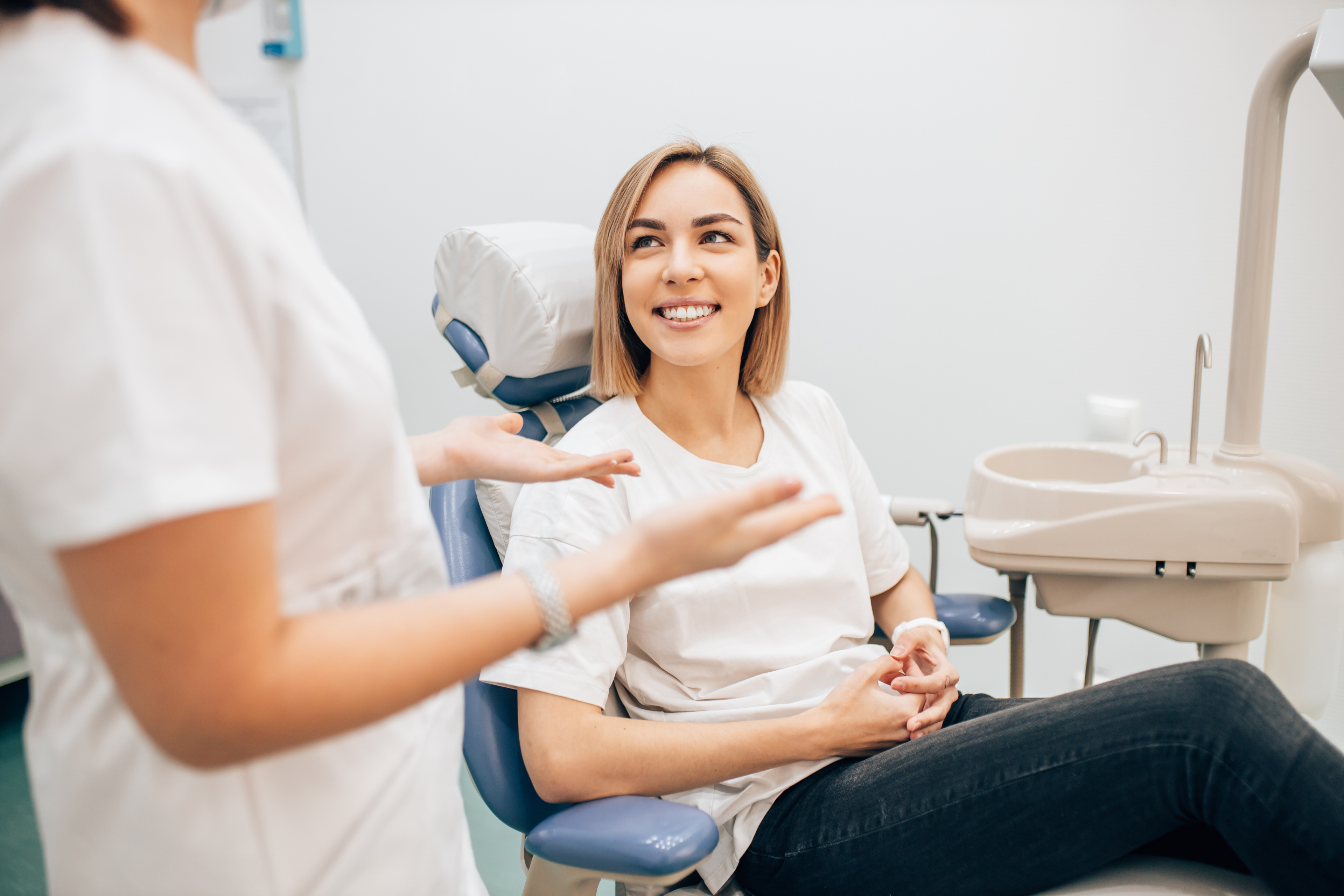 Young accountant sitting in dentist office for consultation