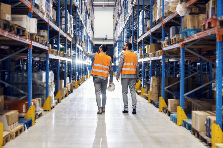 Businessman Showing Storage To His Business Partner.