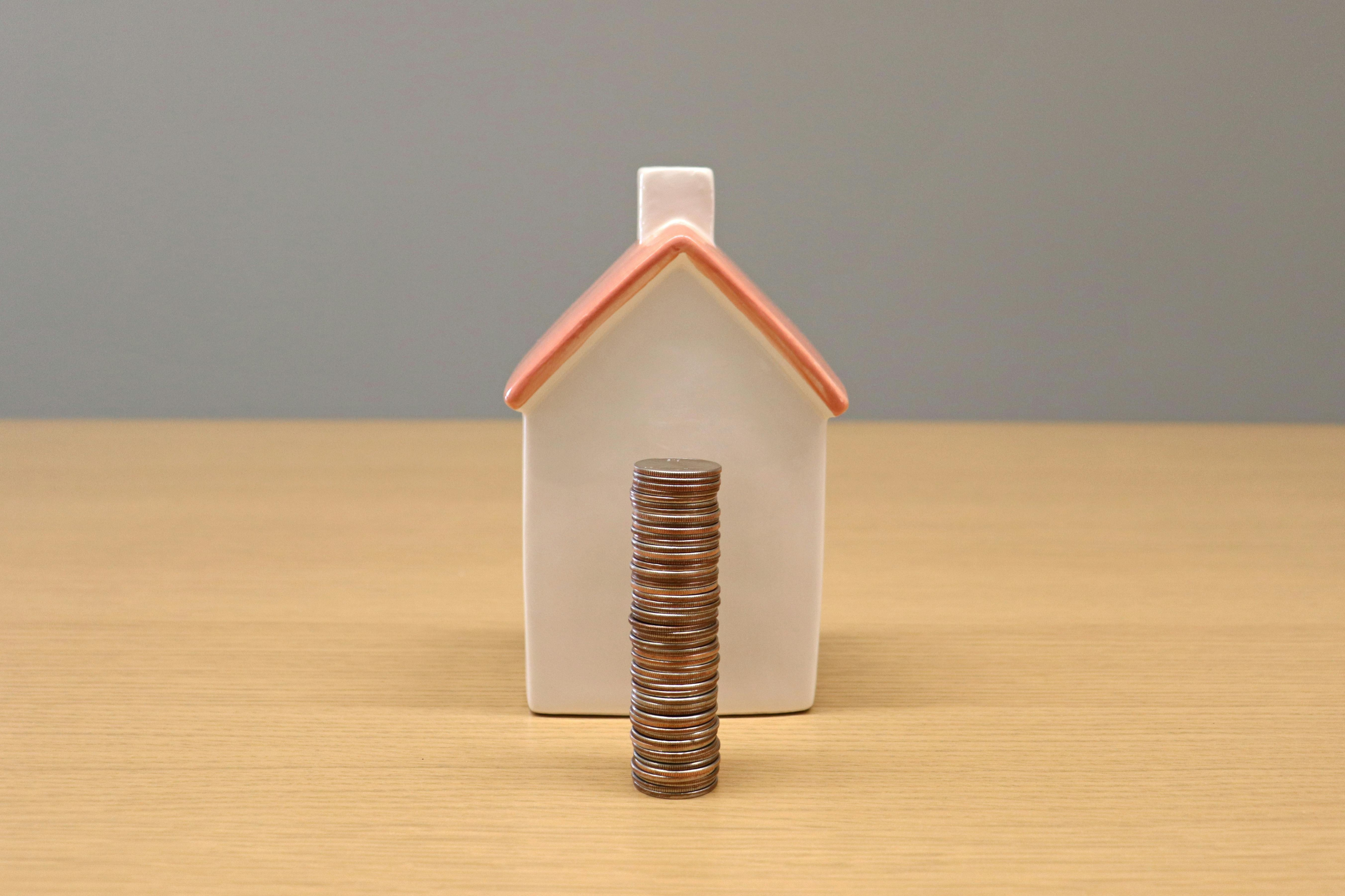 Coins Stacked Infront Of House For Cashflow Management