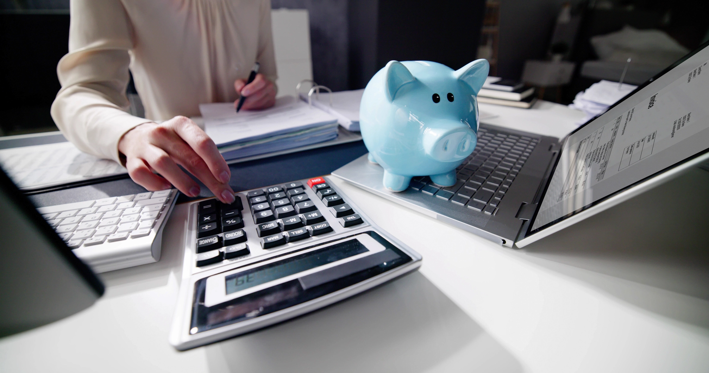Financial Advisor Using Calculator With Piggy Bank For Retirement And Smsf.webp