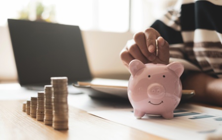 Woman S Hand Putting Coins In The Piggy Bank With 2026 01 07 06 36 50 Utc